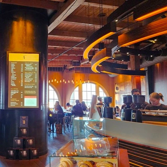 Interior de Storyville Coffee con la barra principal y los comensales al fondo