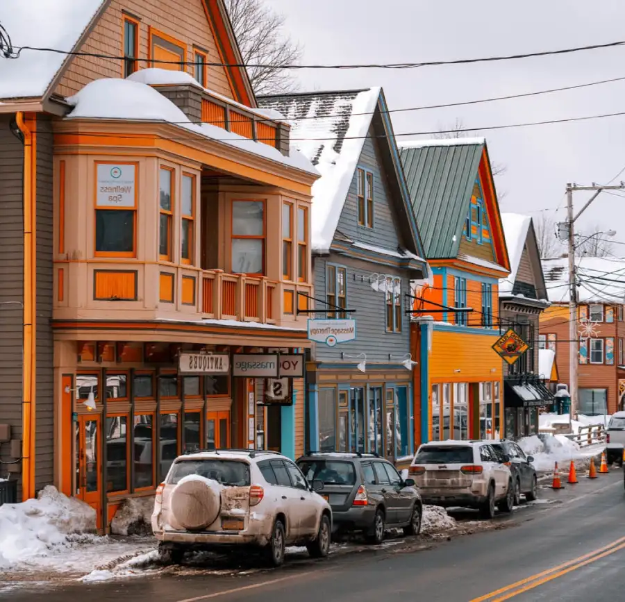 _pueblos_ny_woodstock Calle de Woodstock New York con tiendas y casas coloridas con los techos cubiertos de nieve